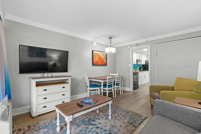 living room with light hardwood / wood-style floors and crown molding