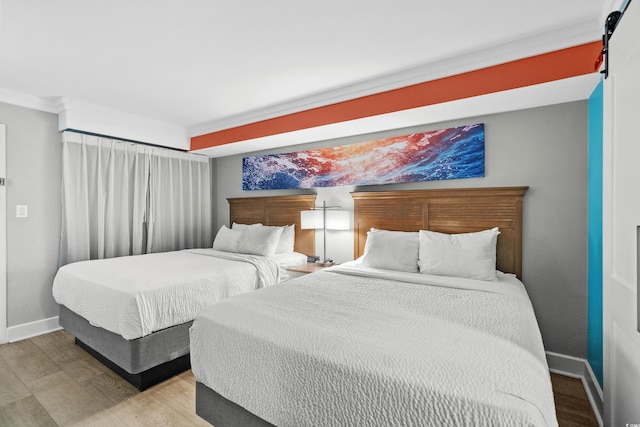 bedroom featuring hardwood / wood-style floors and crown molding