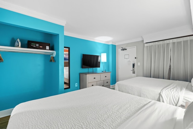 bedroom featuring ornamental molding and hardwood / wood-style floors