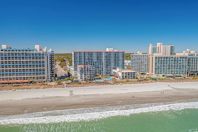 drone / aerial view with a water view and a view of the beach