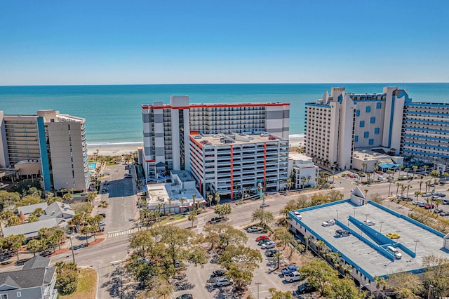 drone / aerial view featuring a beach view and a water view