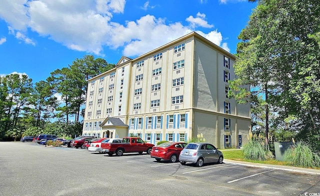 view of building exterior featuring uncovered parking