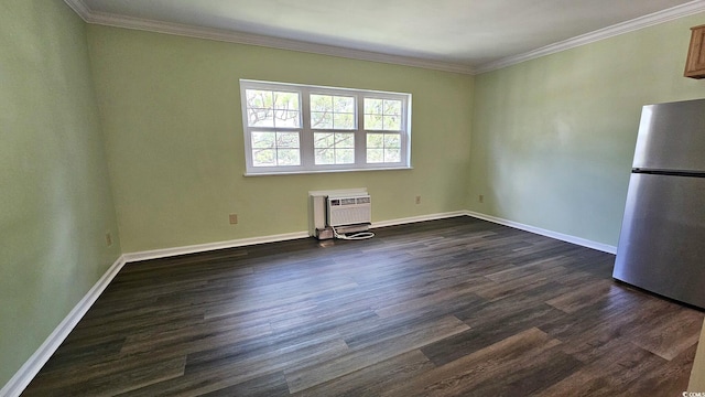 spare room featuring dark wood-style floors, baseboards, crown molding, and a wall mounted air conditioner