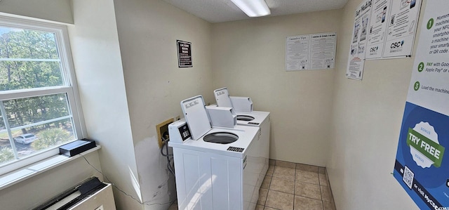 common laundry area with washer hookup, a healthy amount of sunlight, and light tile patterned flooring