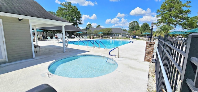 pool with a patio and fence