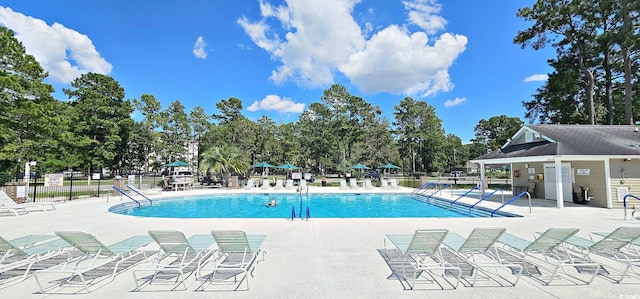 community pool featuring a patio and fence