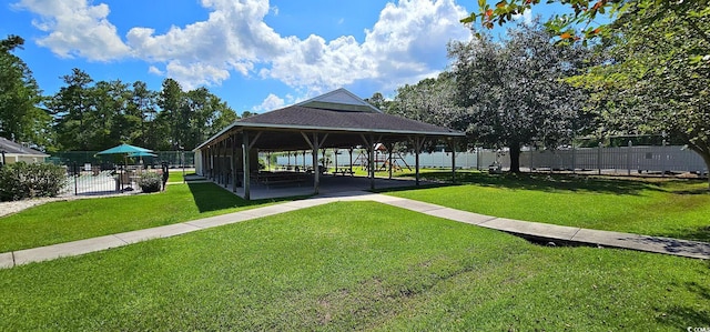 surrounding community featuring fence, a lawn, and a gazebo