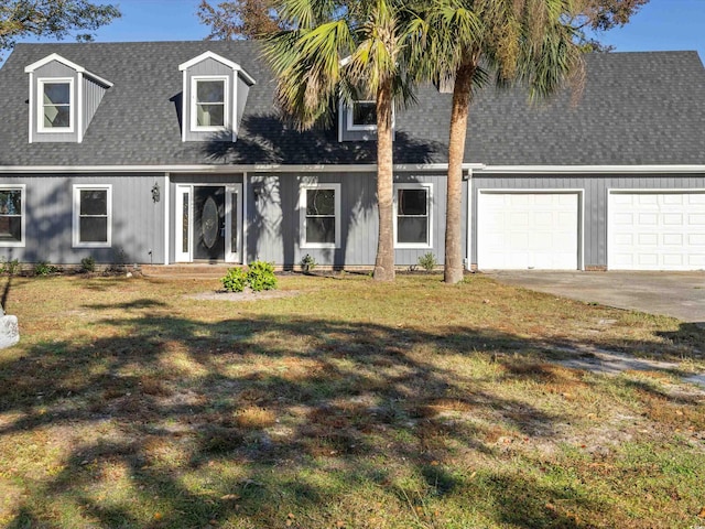 cape cod-style house featuring a front yard and a garage