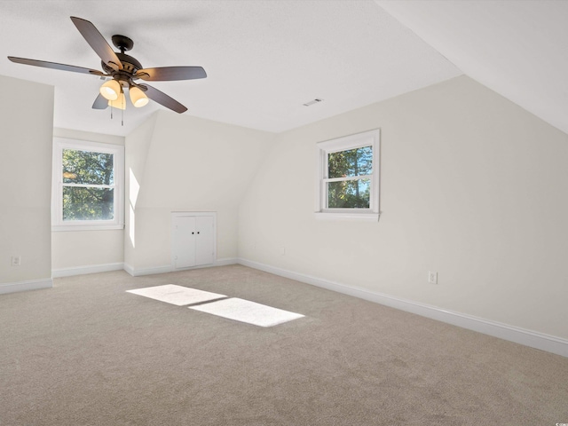 bonus room with vaulted ceiling, ceiling fan, and light colored carpet