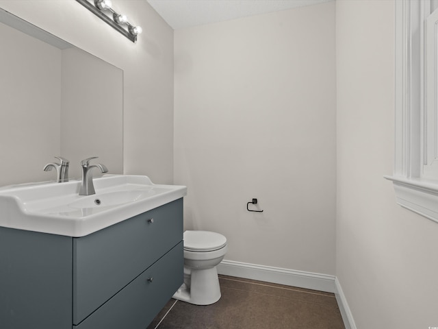 bathroom with vanity, toilet, and tile patterned floors