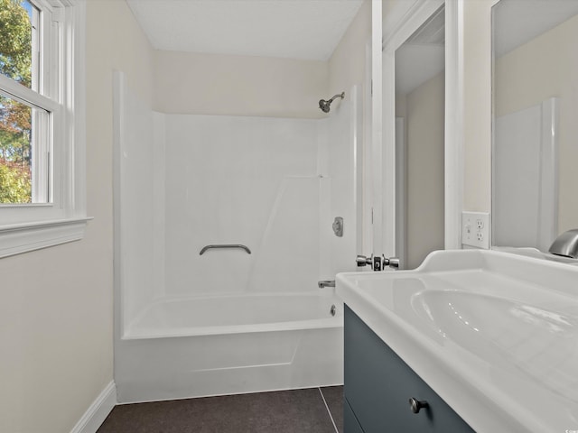 bathroom with bathing tub / shower combination, vanity, and tile patterned floors