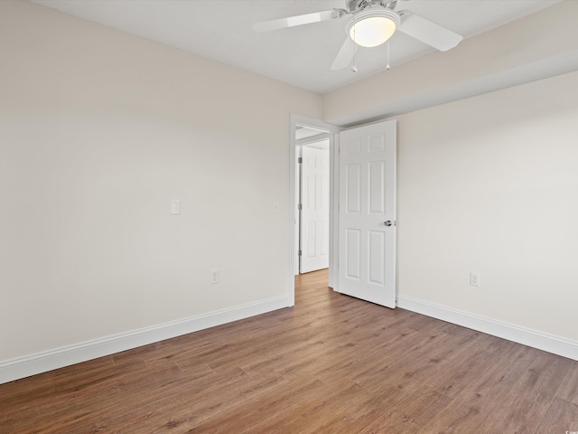 spare room featuring ceiling fan and light hardwood / wood-style floors