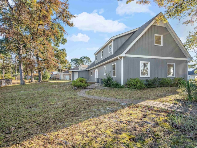 view of home's exterior with a lawn and cooling unit