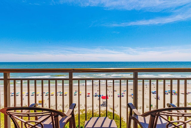 balcony with a beach view and a water view