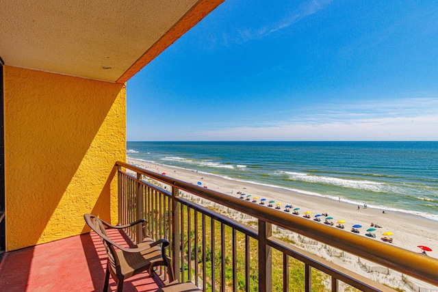 balcony featuring a beach view and a water view