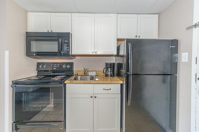 kitchen featuring black appliances, sink, and white cabinetry