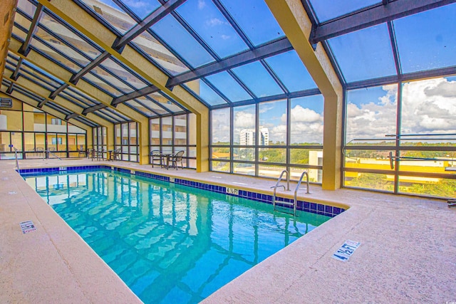 view of swimming pool featuring a lanai and a patio