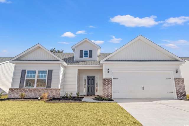 view of front of property with a garage and a front yard