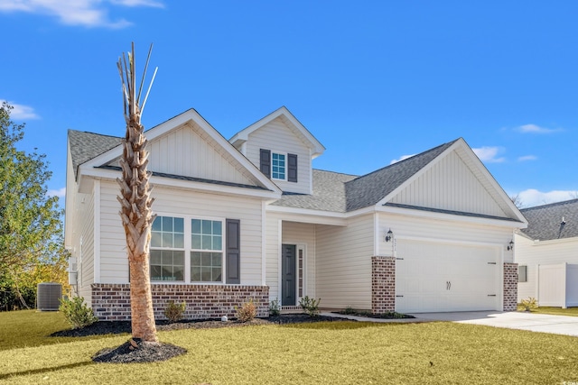 view of front of house with central AC unit, a garage, and a front yard