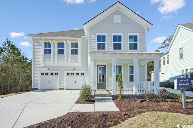 view of front of house with covered porch, concrete driveway, and a garage