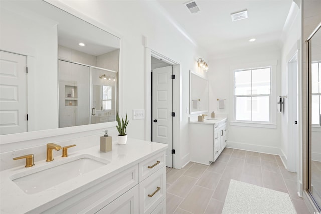 bathroom with a sink, visible vents, two vanities, and a shower stall