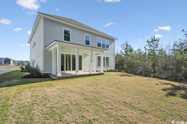 back of property featuring a patio area and a yard