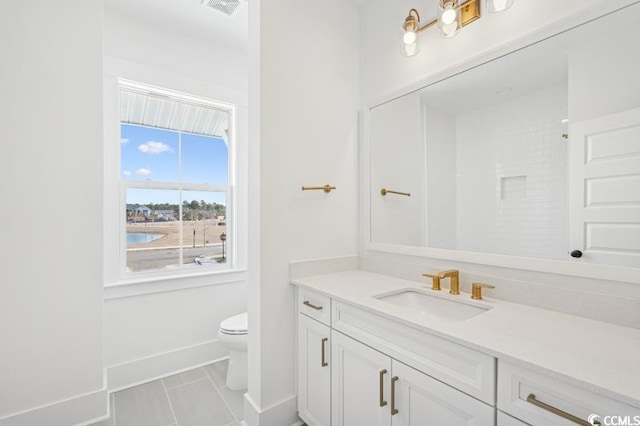 bathroom featuring visible vents, walk in shower, baseboards, toilet, and vanity