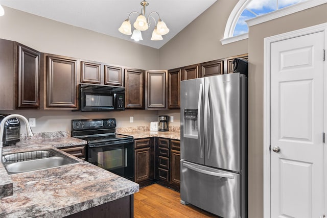 kitchen with vaulted ceiling, an inviting chandelier, dark brown cabinets, black appliances, and sink