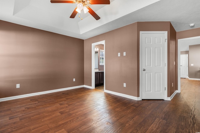 spare room with ceiling fan and dark hardwood / wood-style floors