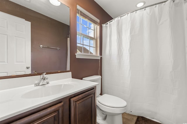 bathroom featuring vanity, toilet, and a shower with shower curtain