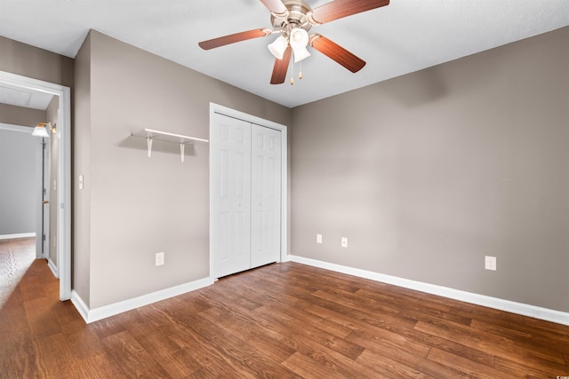 unfurnished bedroom featuring hardwood / wood-style flooring, ceiling fan, and a closet