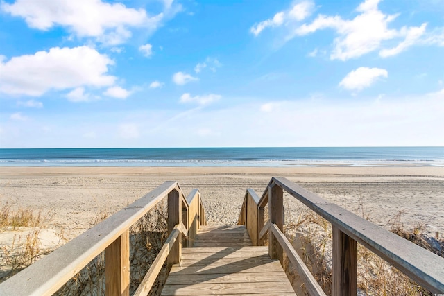 view of community with a beach view and a water view