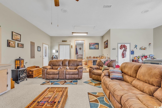 living room with ceiling fan, carpet, and a textured ceiling