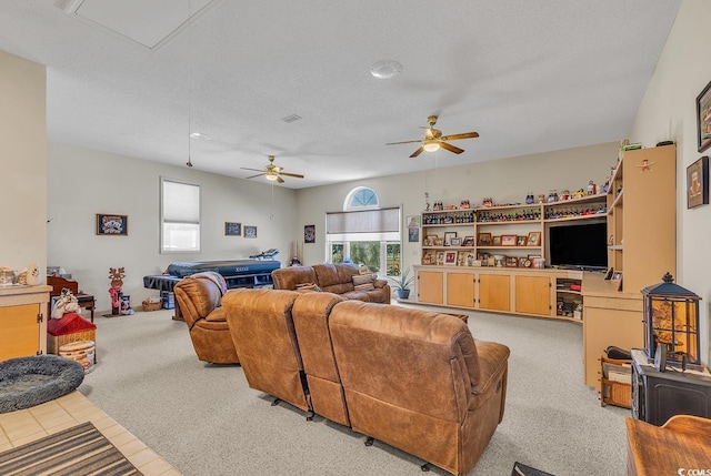 living room with ceiling fan, light colored carpet, and a textured ceiling