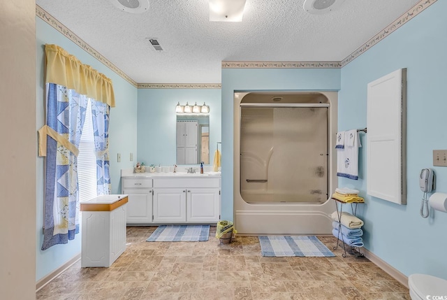 full bathroom featuring bath / shower combo with glass door, visible vents, vanity, a textured ceiling, and baseboards