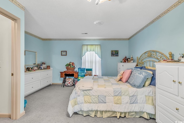 carpeted bedroom featuring crown molding and a textured ceiling