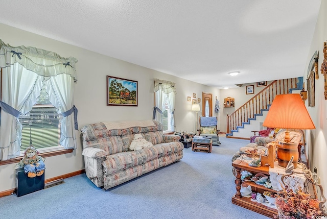 living room featuring a textured ceiling and carpet