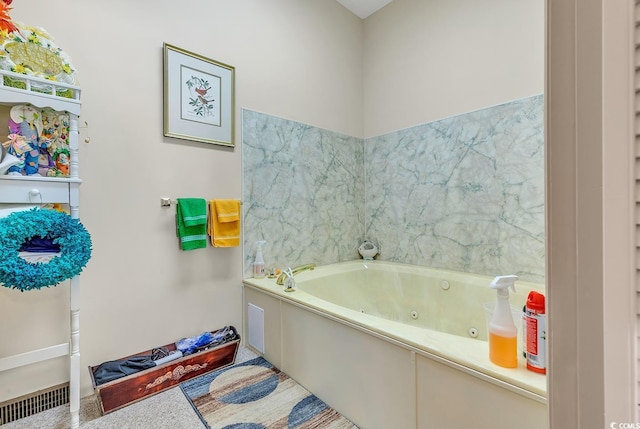 full bath with a whirlpool tub and visible vents