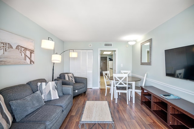 living room featuring dark wood-type flooring