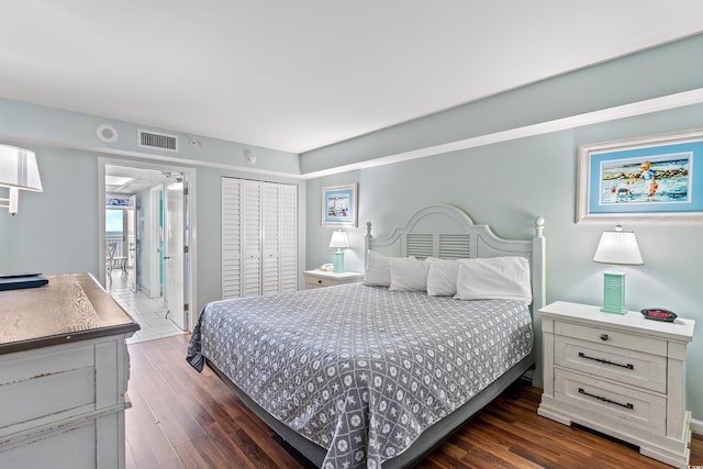 bedroom featuring a closet and dark hardwood / wood-style flooring