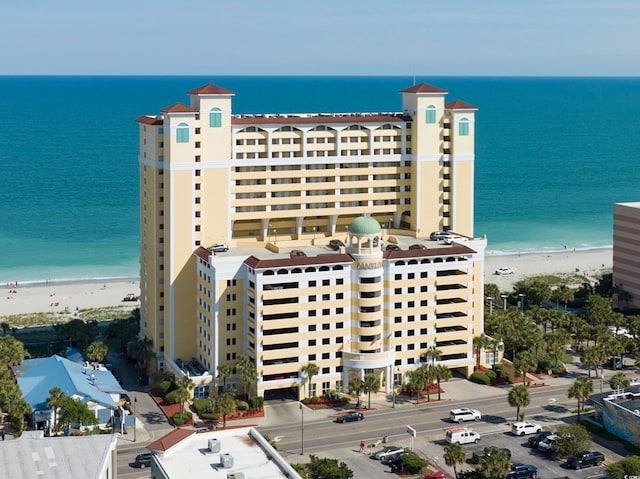 exterior space with a water view and a beach view