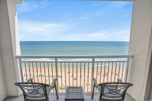 balcony with a water view and a beach view