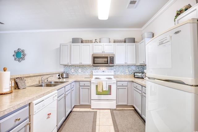 kitchen with crown molding, white appliances, tasteful backsplash, light tile patterned floors, and sink