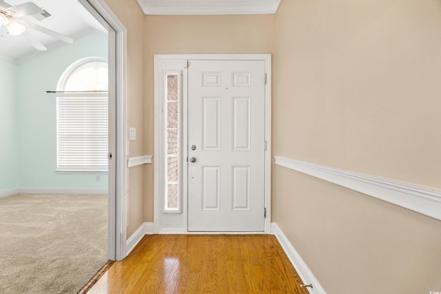 doorway to outside with ceiling fan, light hardwood / wood-style floors, and ornamental molding