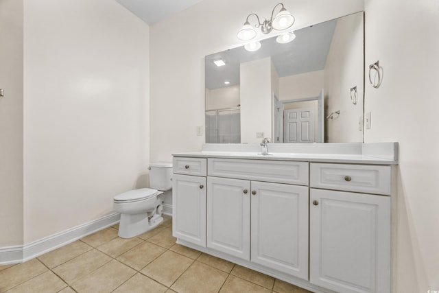 bathroom with vanity, toilet, tile patterned floors, and a shower with shower door