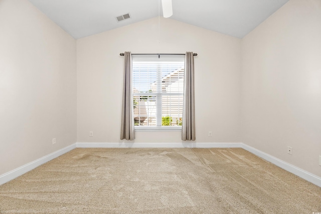 carpeted empty room featuring lofted ceiling with beams