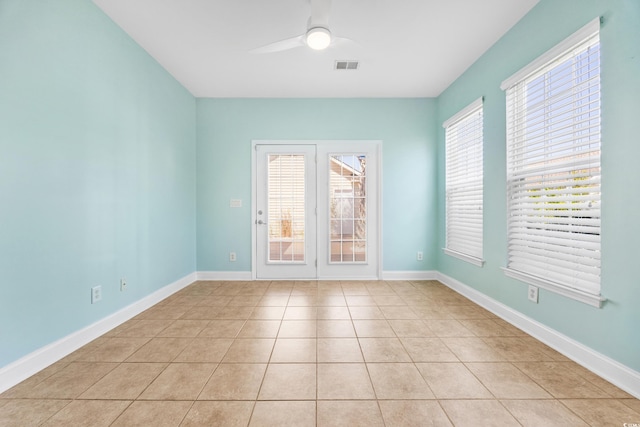 unfurnished room with ceiling fan and light tile patterned floors