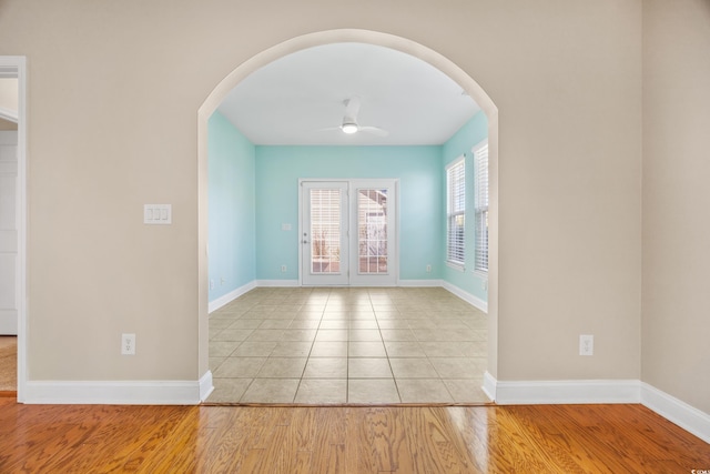 spare room featuring ceiling fan and light hardwood / wood-style flooring