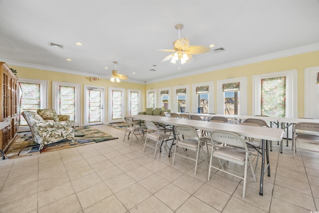 dining room with ceiling fan, plenty of natural light, and crown molding