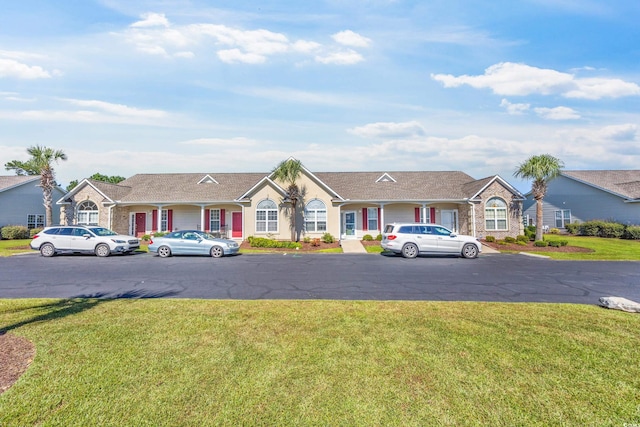 single story home with a front lawn